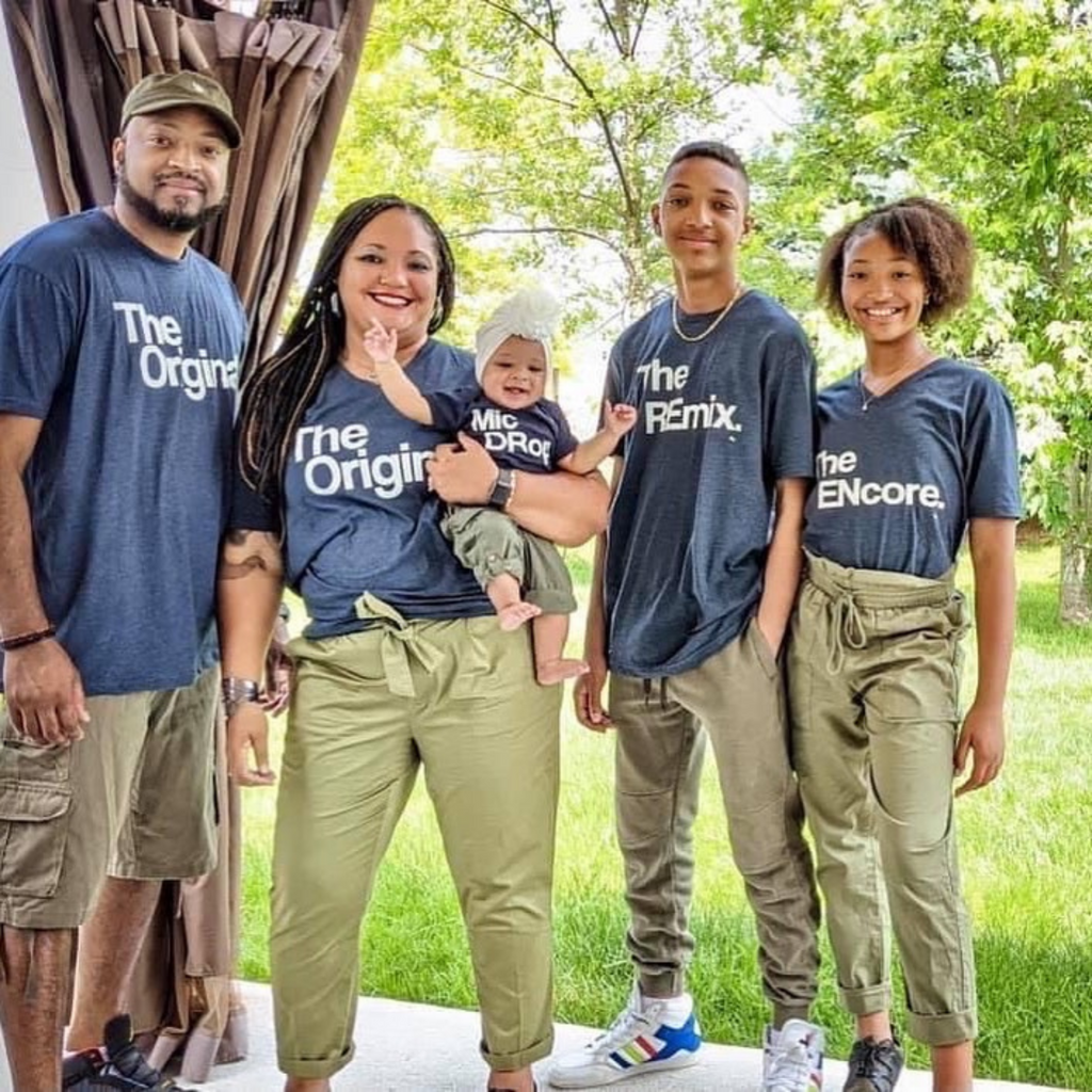 family of 5 wearing matching navy shirts titled the original the remix the encore micdrop shirts in olive matching pants for a fun fall family photo shoot