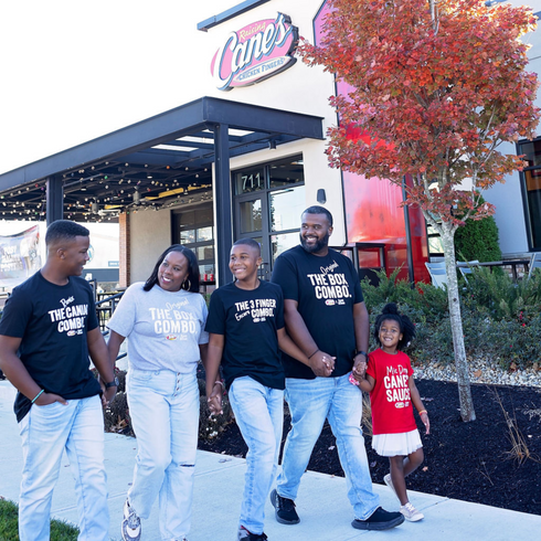 Family of five matching in Raising Canes and Kaans Shirts