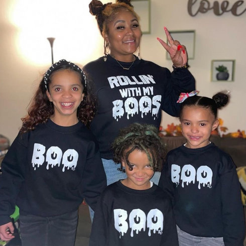 mom matching with 3 kids in halloween sweatshirt sets for halloween