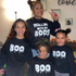 mom matching with 3 kids in halloween sweatshirt sets for halloween