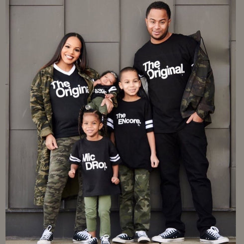husband and wife and kids wearing football style matching shirts with screen print design the original the remix the encore mic drop and a fresh new beat accenting with camo jackets and pants