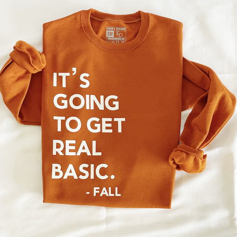 pumpkin orange sweatshirts with screen print text that says its going to get real basic fall, this is a fall sweatshirt, flat lay